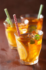 ice tea with lemon and mint on dark rustic background
