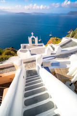 Oia town on Santorini island, Greece. Traditional and famous houses and churches with blue domes over the Caldera, Aegean sea