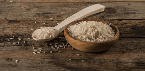 a bowl of rice on wooden surface