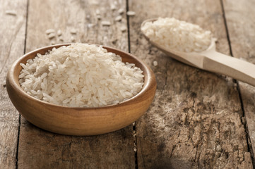 Fototapeta na wymiar a bowl of rice on wooden surface
