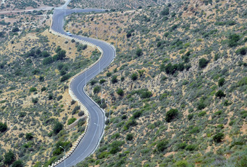 A winding mountain road with a bird's eye view of Agadir, Morocco