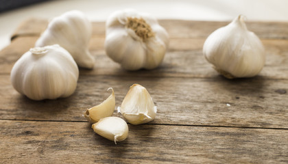 Garlic cloves on wooden vintage background.