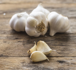 Garlic cloves on wooden vintage background.
