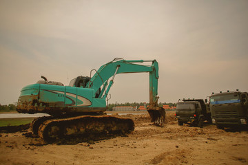 Obraz premium Excavator or backhoe at the construction site with Pale sky