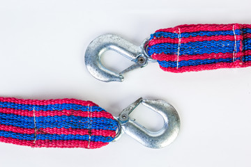 Blue/red towing rope with metal hooks isolated on a white background.