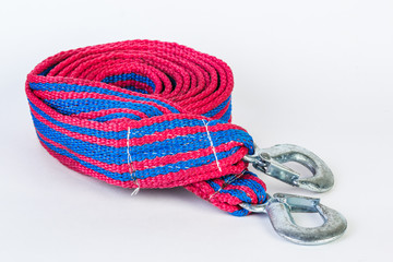 Blue/red towing rope with metal hooks isolated on a white background.