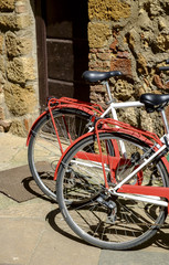 Fototapeta na wymiar Bicycles in a street in the village of Pienza Tuscany