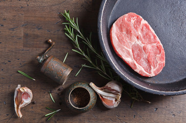 Pork steak with rosemary, garlic and pepper , top view