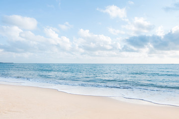 Beautiful white sand beach and ocean waves with clear blue sky background