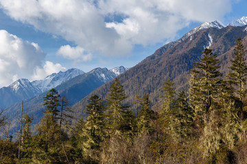 Beautifull cloudy sunrise in the mountains with snow ridge
