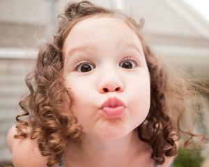 Curly hair child kissing