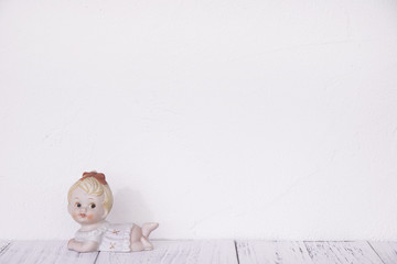 Stock photography retro white wall wooden vintage paint floor and ceramic doll toy cute baby