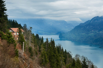 house on the hill near river in interlaken switzerland