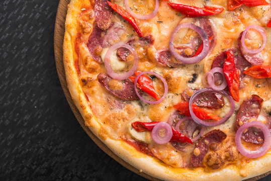delicious pizza with salami, onion and pepperoni