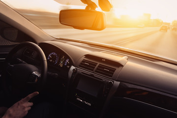 Drive car at high speed at sunset