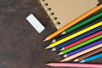 Color pencil and notebook  on wood table