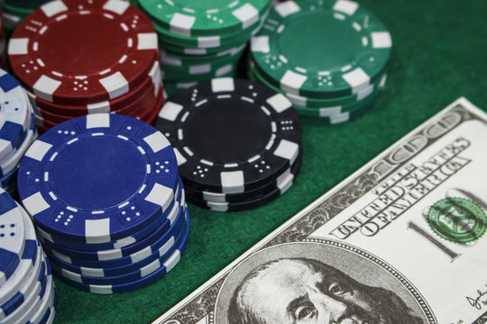Poker chips and money on the green table