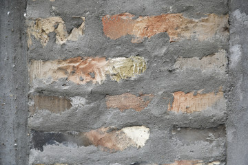 Brick wall covered with cement in construction