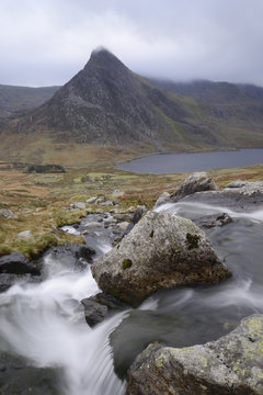 Water cascading down a fall on the Afon Lloer, overlooking the Ogwen Valley and Tryfan in the Glyderau mountain range, Snowdonia, Wales
