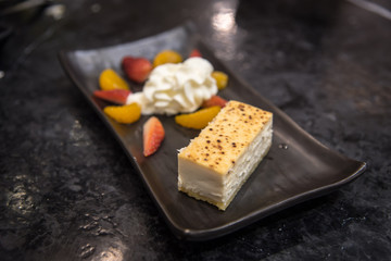 Cheesecake with orange and strawberry whip cream
