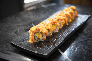 Sushi rolls salmon top with sauce