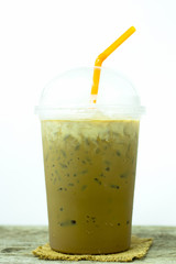 Ice coffee mug with white backdrop,on wood