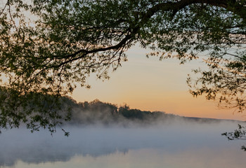 A view of the fog over the river in the early morning. Selective focus