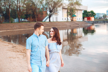 Fototapeta premium happy romantic couple in love and having fun at the lake outdoor in summer day, beauty of nature, harmony concept