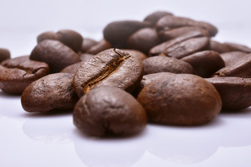 Roasted coffee beans isolated in white background.