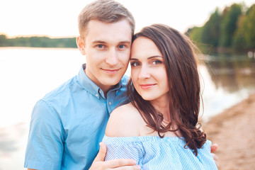 Close up romantic beauty portrait of happy couple in love hugs and having fun, evening sunlight,