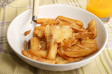 french fries with melted irish cheddar cheese and orange juice