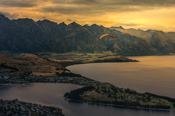 Paragliding over Queenstown and Lake Wakaitipu from viewpoint at Queenstown Skyline, New Zealand