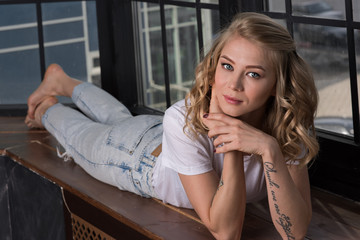 Portrait of a girl lying on the windowsill