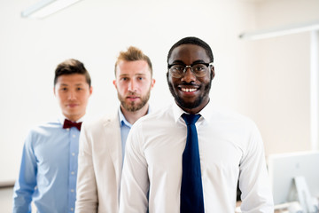 Three business man posing - standing in line