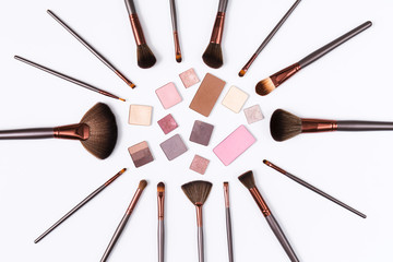 Decorative eyeshadow and makeup brushes flat lay
