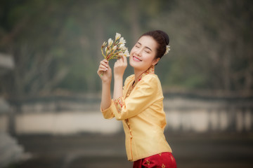 Laos woman in Laos traditional dress feeling joyful  with flower
