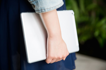 Young asian lady holding tablet