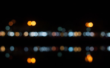 Light green in the dark. Abstract background of out of focus lights at night. Light hexagon.