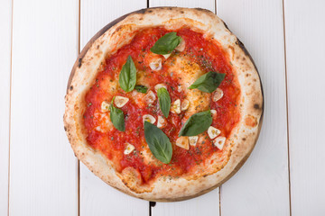 Whole pizza on wooden board