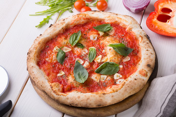 Whole pizza on wooden board