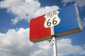 Historic Road 66 road sign against a blue sky with clouds in the State of Texas, USA; Concept for travel in the USA and Road Trip
