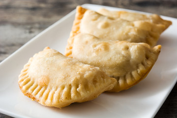 Typical Spanish empanadas on wooden table
