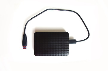 External hard drive with usb cable, isolated on white background.