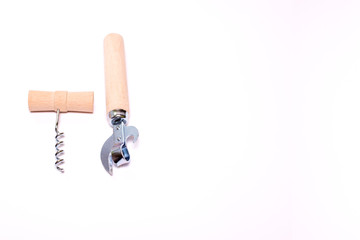 corkscrew with wooden handle and vintage can opener with wood handle isolated on white background