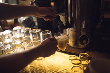 Man bartender pouring hot water in a tea