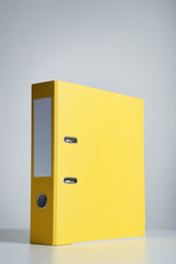 Yellow office folder on grey background