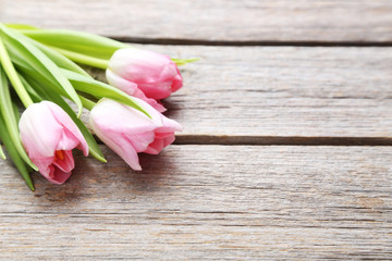 Bouquet of tulips on a grey wooden table