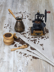 coffee grinder with coffee beans on a wooden table. 