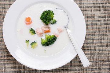 cream soup with salmon, broccoli and vegetables