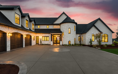 Stunning Luxury Home Exterior at Sunset with Colorful Sky and Expansive Driveway. This Mansion has...